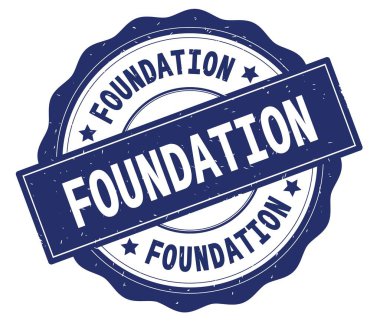 Mavi yuvarlak rozet yazılmış Vakfı metni,.