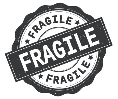 Gri yuvarlak rozet yazılmış kırılgan metni.