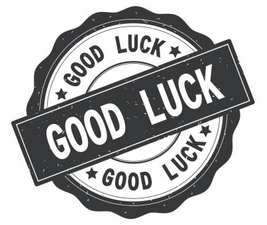 Gri yuvarlak rozet yazılmış iyi şanslar metni.