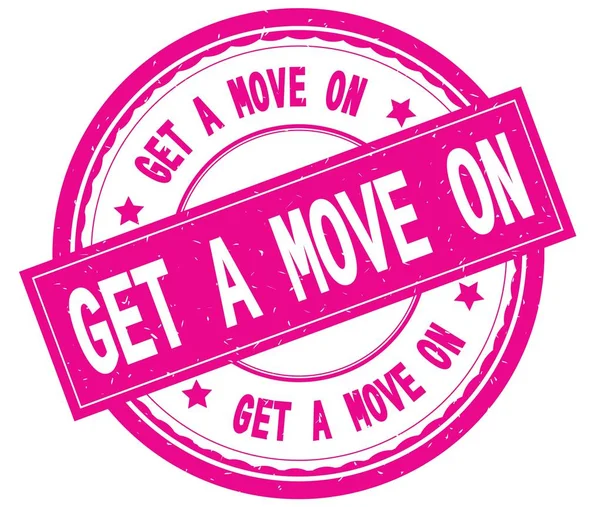 GET A MOVE ON , written text on pink round rubber stamp. — Stock Photo, Image