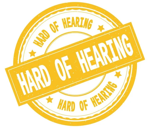 HARD OF HEARING, teks tertulis pada stempel karet bundar kuning . — Stok Foto