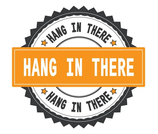 HANG IN THERE text on grey and orange round stamp, with zig zag — Stock Photo, Image