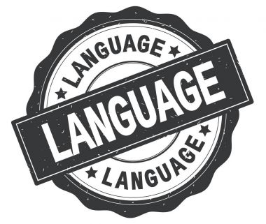 Gri yuvarlak rozet yazılı dilde metin.