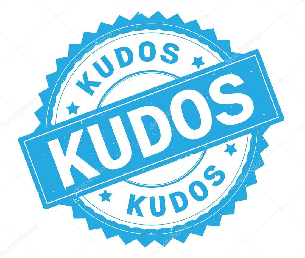 KUDOS blue text round stamp, with zig zag border.