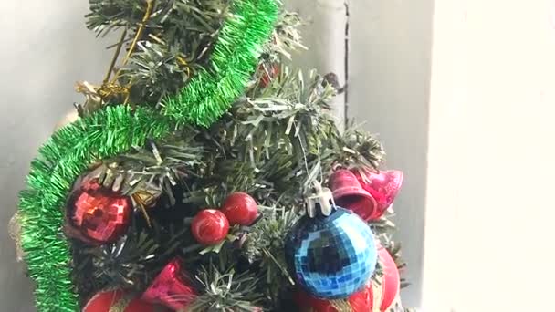 Beautiful, festive Christmas fir tree, artificial with toys in the room — Stockvideo