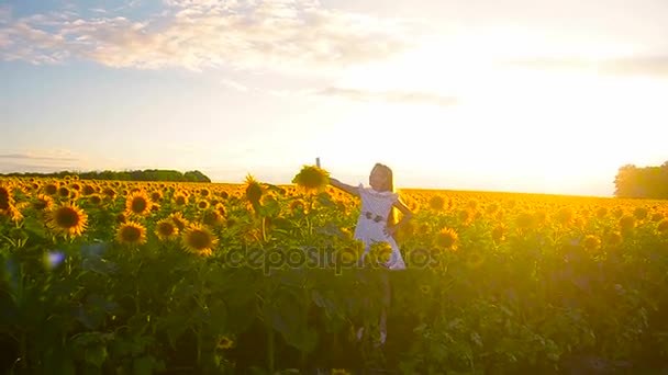 Young girl taking pictures in field of sunflowers phone online photo girls on sunflower background. — Stock Video