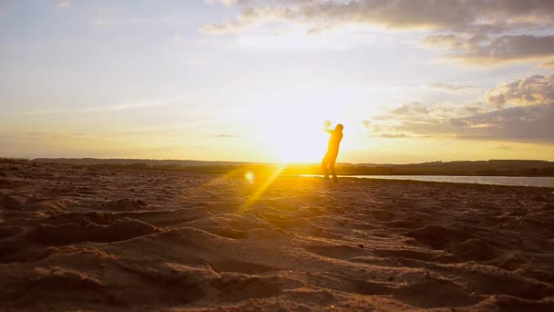 Тренировочный мальчик играет в волейбол на песке, мальчик бьет мяч руками на пляже на солнце . — стоковое видео