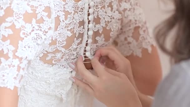 Beautiful white dress button up buttons on back of the girl — Stock Video