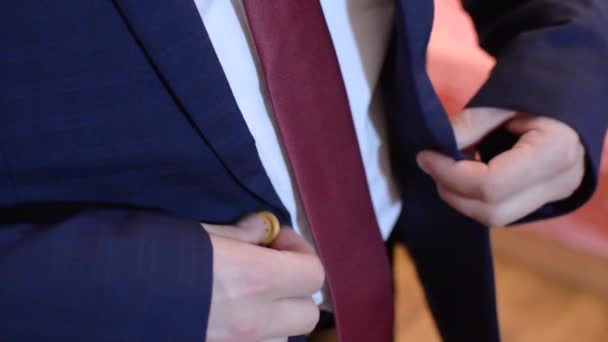 Man buttoning button on suit jacket, close-up — Stock Video