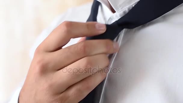 Man wears a black tie on white shirt, close up — Stock Video