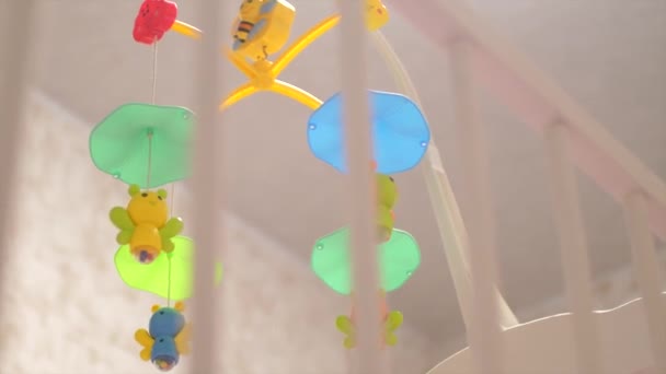 Bright and colorful spinning toys in crib. Slow motion, — Stock Video