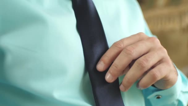 Man ties up dark blue tie. morning man dresses for work — Stock Video