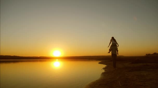 Šťastný otec a dcera hraje na pláži při západu slunce — Stock video