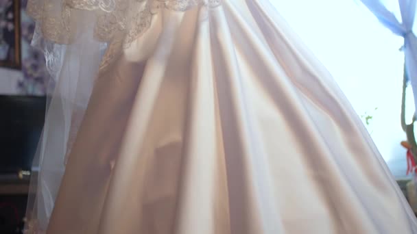 Bride in white beautiful dress stands by the window — Stock Video