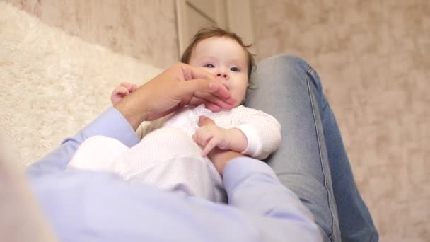 Pappa spelar med baby, glada lilla barnet sitter på pappa — Stockvideo