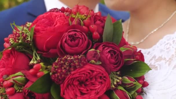 Mann umarmt Mädchen, Mädchen hält einen Strauß roter Rosen, Nahaufnahme — Stockvideo