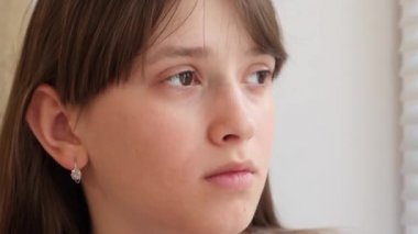 Kız kupa c hoş kokulu kahve içme ve gülümseyen tutuyor. Çay ile kız pencereden görünüyor.