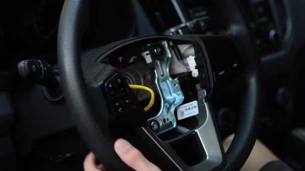 Man is repairing leather steering wheel in car. — Stock Video