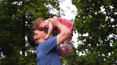 Mutlu baba onun sevgili kızı onu yanağından öpüyor ve gülümseyen kucağında holding.