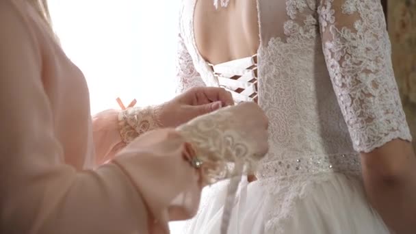 Girl dresses beautiful white dress for the wedding — Stock Video