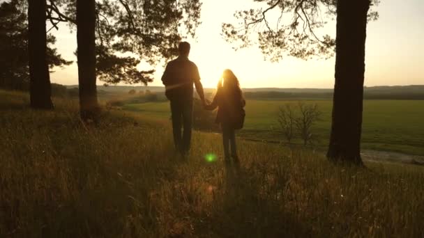 Father and daughter travel, walk through the woods, enjoy the scenery at sunset. Lovers travelers travel with backpacks. Happy family of tourists on vacation travels. Romance. Hiker Girl. Slow motion. — Stock Video