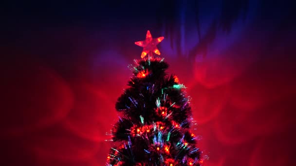 Christmas tree, happy holidays. Christmas interior. beautiful Christmas tree in room, decorated with a luminous garland and a star. holiday for children and adults. New Year 2020 mood. — Stock Video