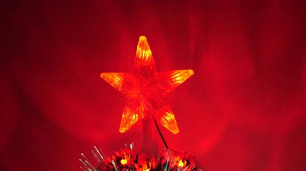 beautiful christmas star shining on christmas tree. New Year 2020 mood. Christmas tree, happy holidays. Christmas interior. holiday for children and adults.