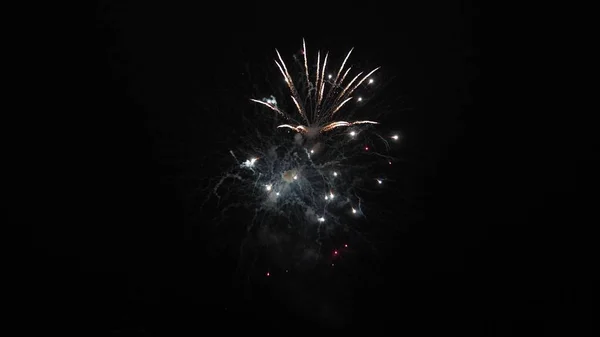 Beautiful multi colored fireworks in night sky. New years eve fireworks celebration. shining fireworks with bokeh lights in the night sky. glowing fireworks show. colored night explosions in black sky — Stock Photo, Image