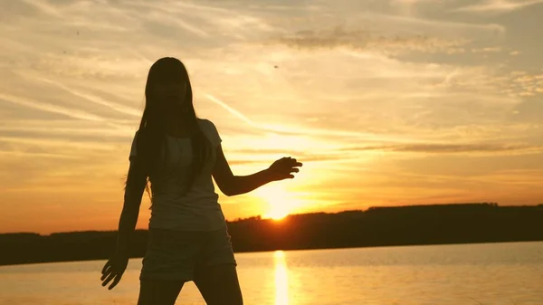 Young woman dancing at a sunset party. Free and cheerful woman. Happy girl with long hair is dancing at sunset on the beach and laughing. Slow motion. — Stock Photo, Image