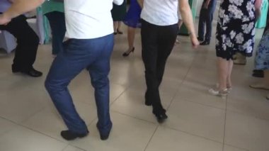 the legs of a man and woman are dancing fun and sexually. fun party. club dance party. people dance at a concert in the club. holiday concept.