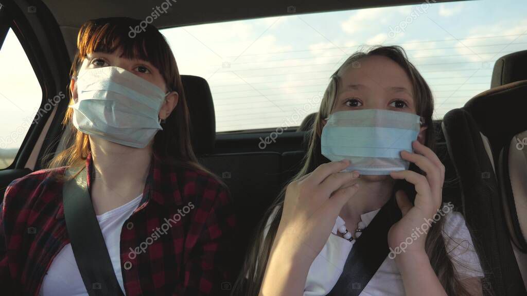 Healthy young woman in protective sterile medical mask drives a car. concept of pandemic coronavirus. free girl travels in a mask in a car. protection against viruses and bacteria. a girl rides a car