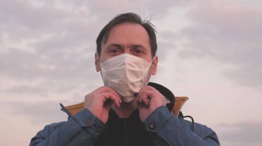 Salgın hayatta kalma konsepti. Virüs ve bakterilere karşı koruma. Gün batımında koruyucu bir maske takan özgür bir kadın. Sağlık ve güvenlik konsepti, koronavirüs N1H1, koruma.