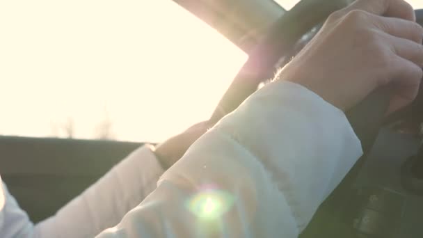 Hands of free woman hold steering wheel of car close up. healthy girl travels in a automobile. female rides vehicle. free girl drives a car. palms hold steering wheel drives car — Stock Video