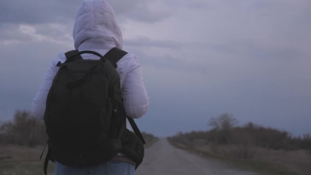 Gesunde Reisende mit Rucksack und Schutzmaske gehen außerhalb der Stadt auf der Straße spazieren. Pandemische Coronavirus Free girl Schutz vor Viren und Bakterien. Gesundheits- und Sicherheitskonzept — Stockvideo