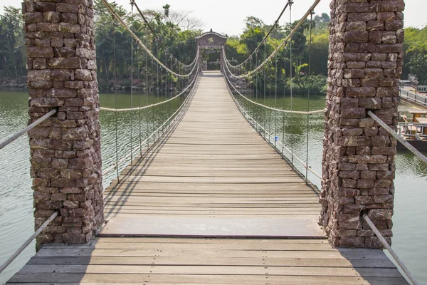 Wooden bridge across the river — Stock Photo, Image
