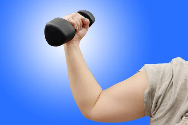 Hands holding dumbbells in sport club on blue background — Stock Photo, Image