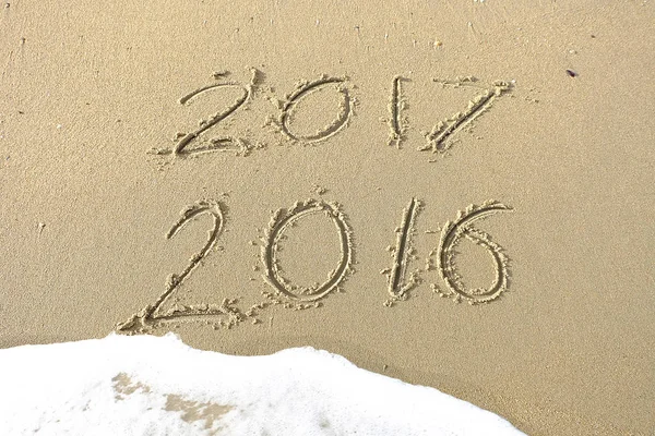 Good bye 2016 hello 2017. inscription written in the beach sand.