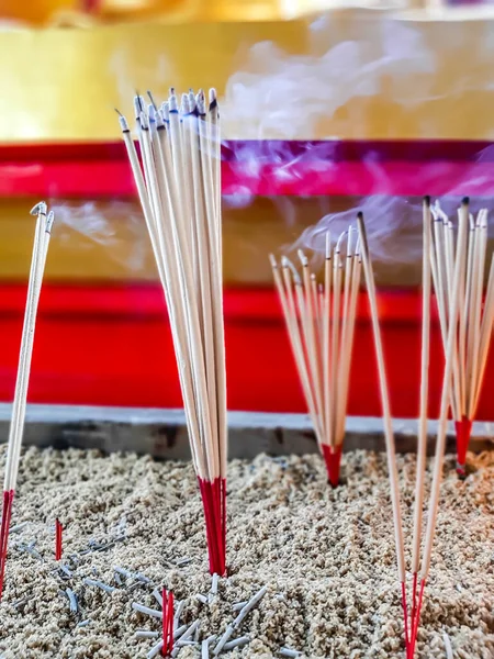 Close up burning incense sticks and smoke from incense burning.Incense to worship what respect.