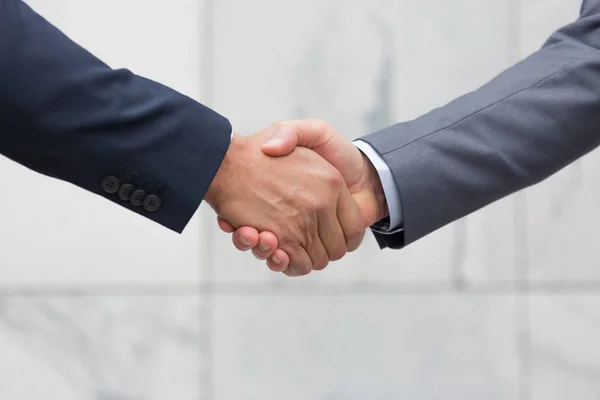 Closeup Businessmen Wearing Suits Shaking Hands Meeting Standing Modern Office — Stock Photo, Image