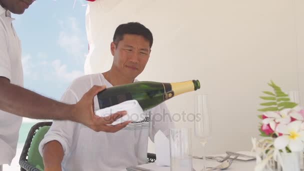 Young Man Wearing White Shirt Watching Waiter Pouring Champagne Glass — Stock Video