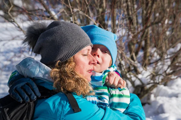 Mother Hugging Her Son Snow – stockfoto