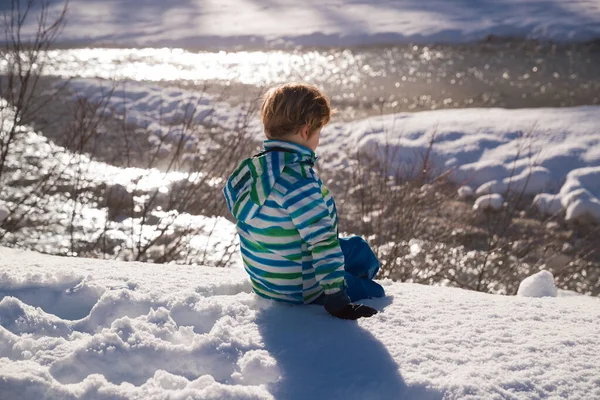 Zon Flared Van Kleine Jongen Zittend Sneeuw Zonnige Dag — Stockfoto