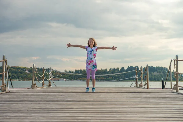 Little Girl Stretching Out Her Arms Pier Sunset — kuvapankkivalokuva