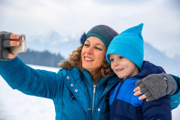 Mother Son Taking Selfie Snow – stockfoto