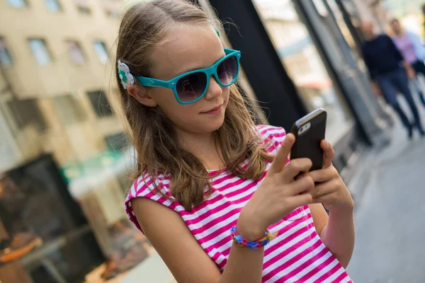 School Girl Browsing Smartphone City stockbilde
