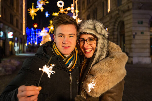 Couple Smiling Holding Sparklers Stock Picture