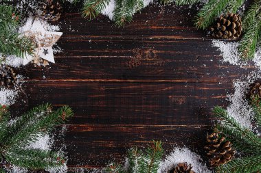 Christmas background, Fir-trees and cones on a wooden table, cru