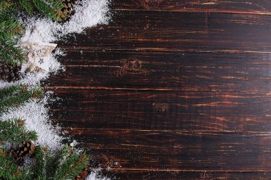 Christmas background, Fir-trees and cones on a wooden table, cru