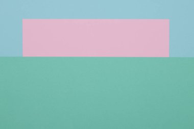 Mavi, yeşil ve pembe arkaplan, renkli kağıt geometrik olarak bölgelere bölünür, çerçeve, boşluk kopyala.