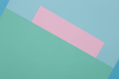 Mavi, yeşil ve pembe arkaplan, renkli kağıt geometrik olarak bölgelere bölünür, çerçeve, boşluk kopyala.